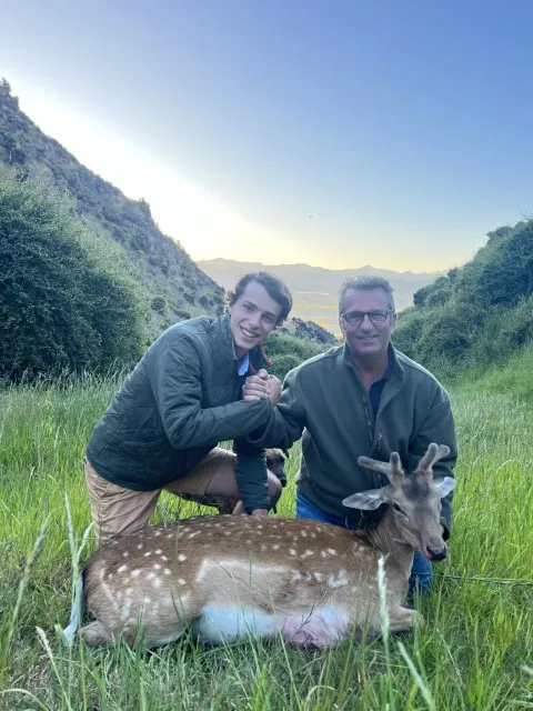 two men with their deer they caught on their hunting trip