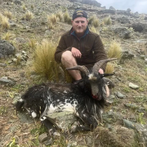 man with goat hunting central otago